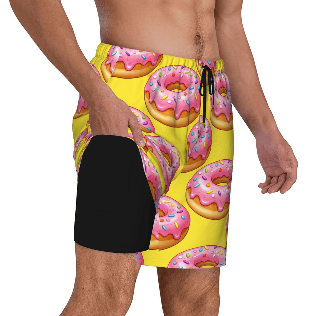Yellow swim shorts with pink donut pattern on a white background