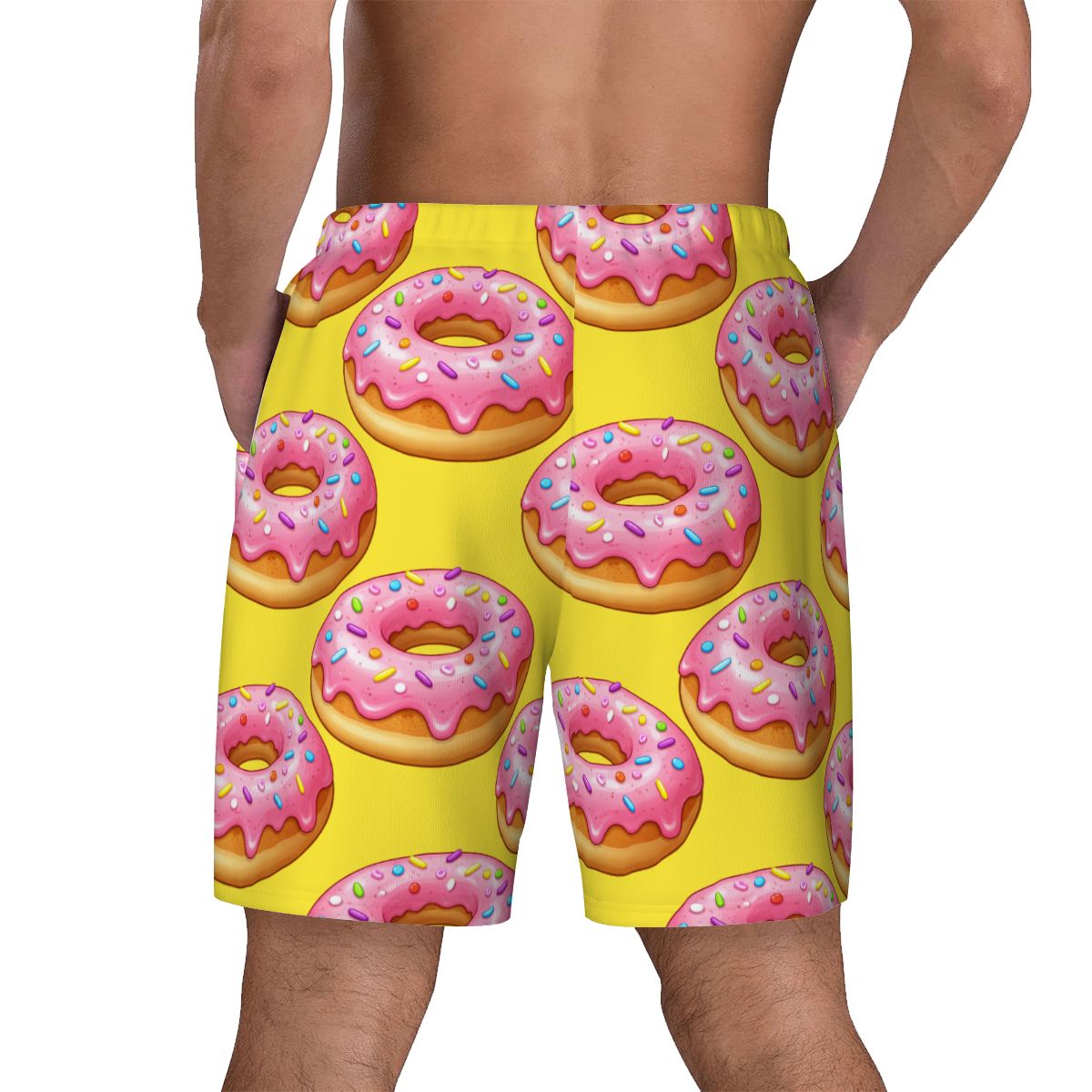 Bright yellow swim shorts with pink donut pattern on a white background