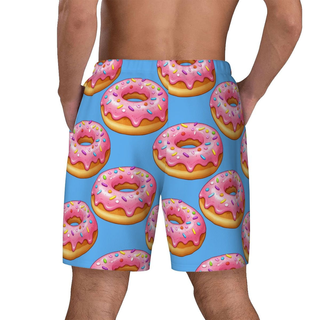 Blue swim shorts with pink donut pattern on a white background