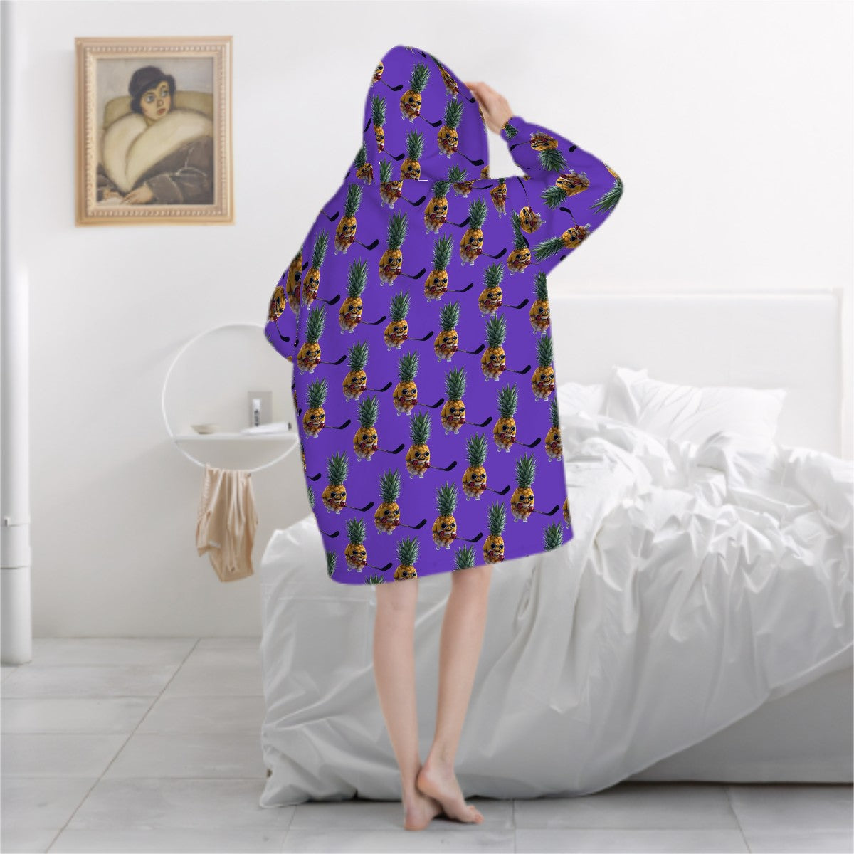 Person wearing a purple hoodie with pineapple pattern in a bedroom setting